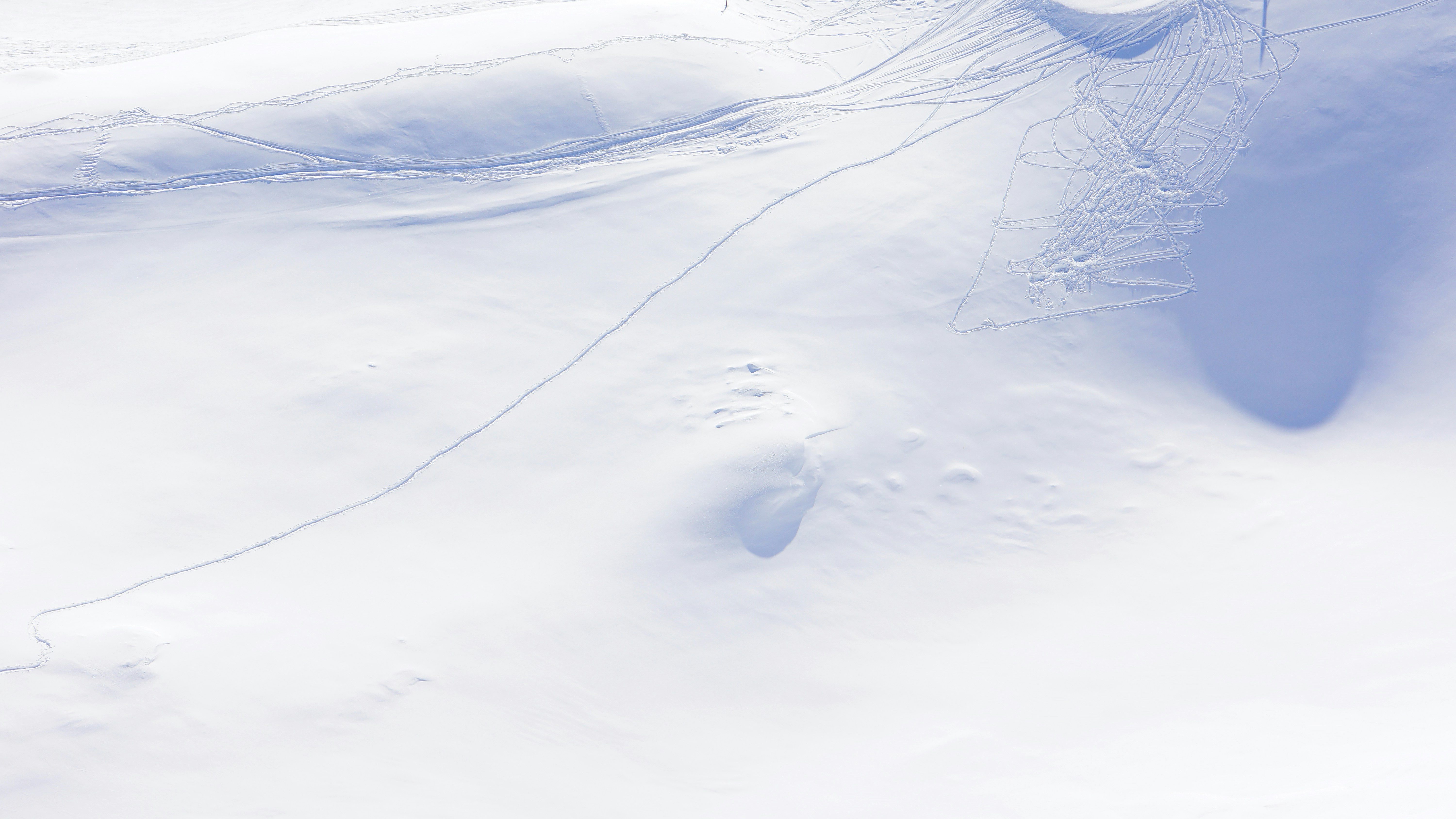 an aerial view of a snow covered mountain