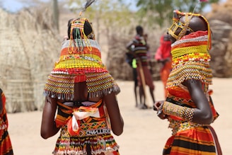 a group of women in colorful clothing standing next to each other