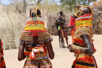 a group of women in colorful clothing standing next to each other