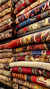 a pile of rugs are stacked on top of each other