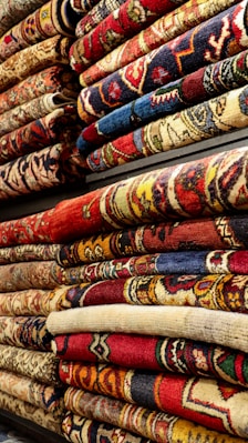 a pile of rugs are stacked on top of each other