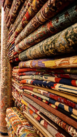 a large collection of rugs and carpets on display