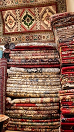 a pile of rugs sitting on top of a wooden floor