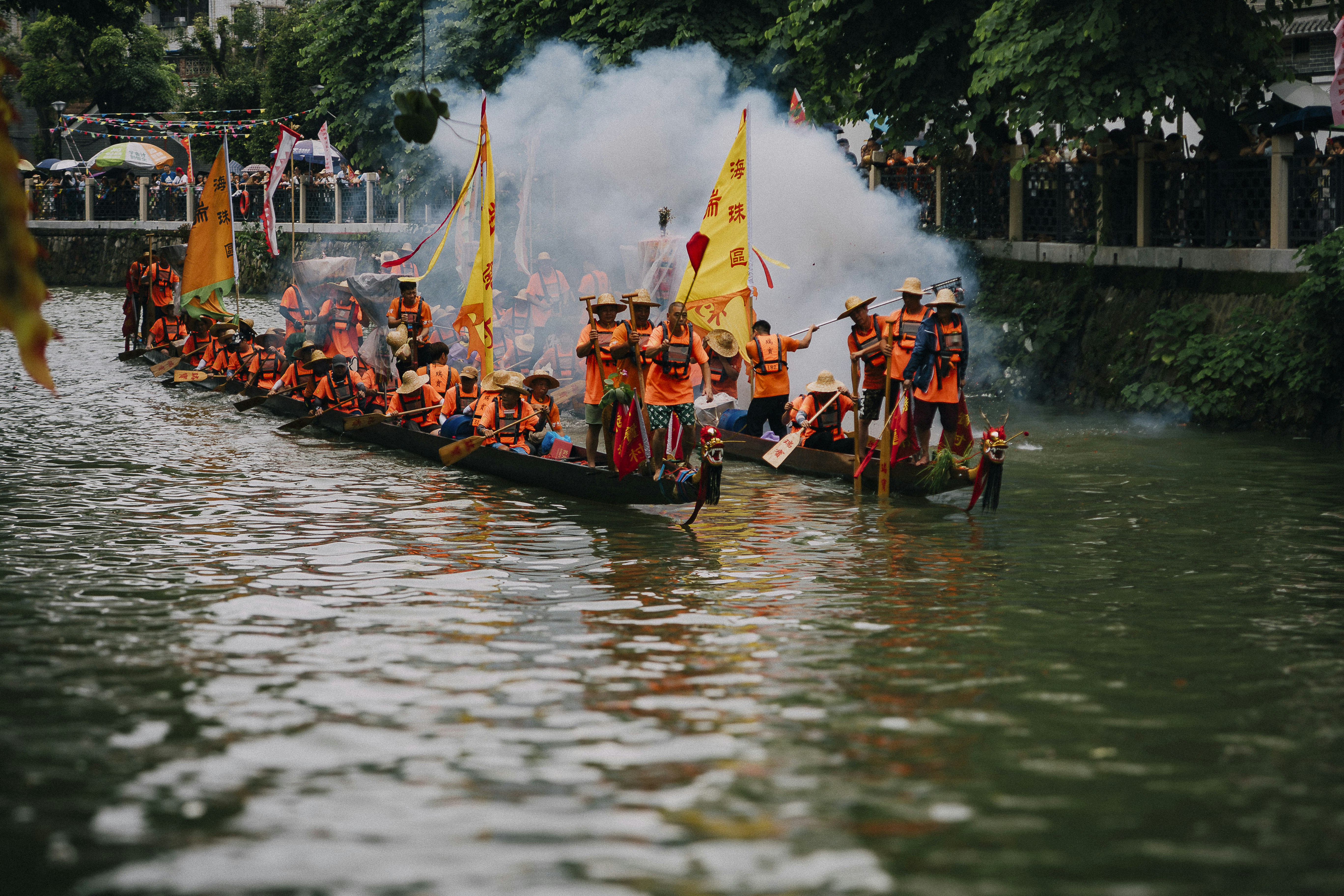 a long boat filled with people on top of a river