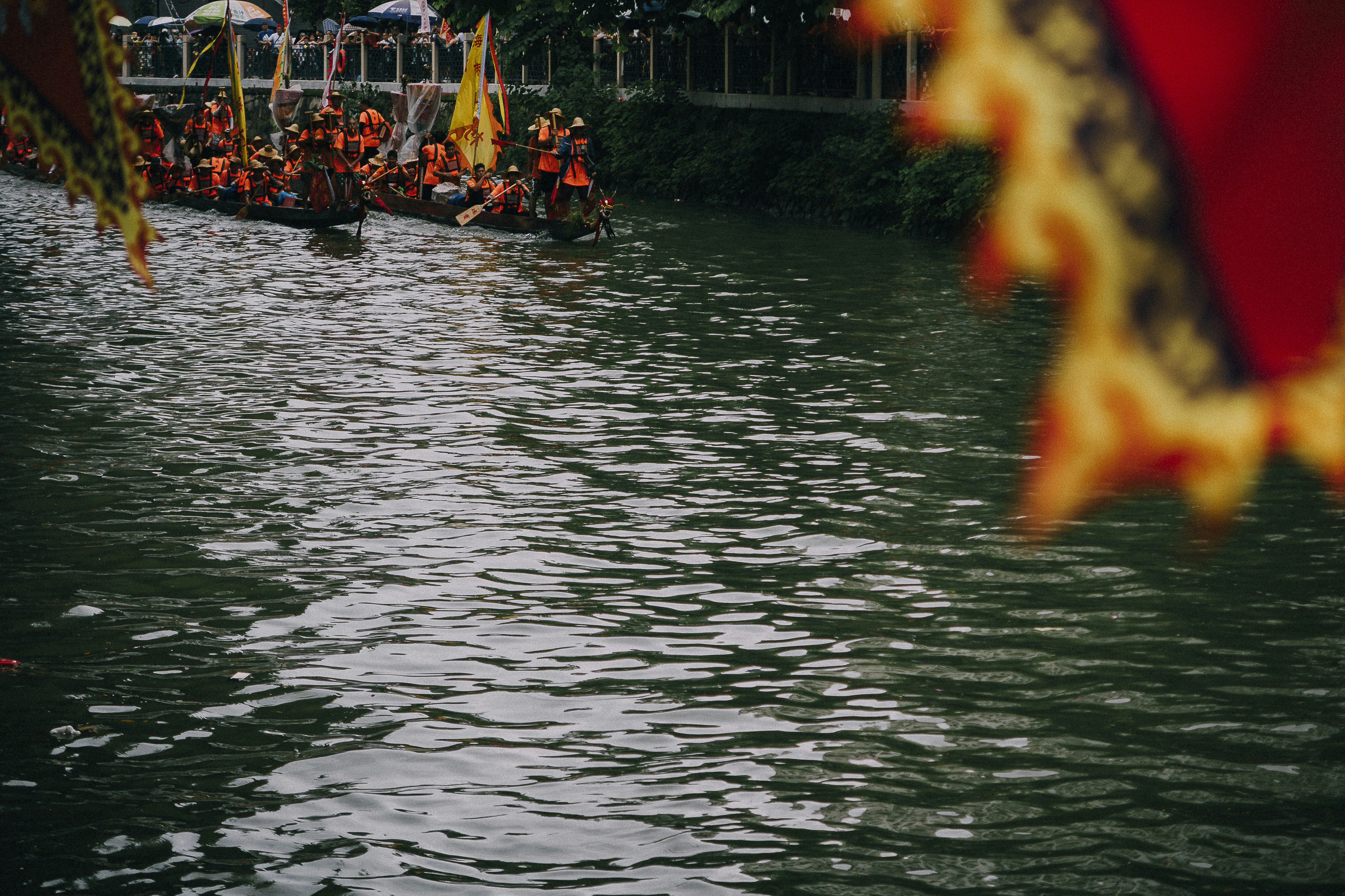 a group of people riding on top of a boat down a river