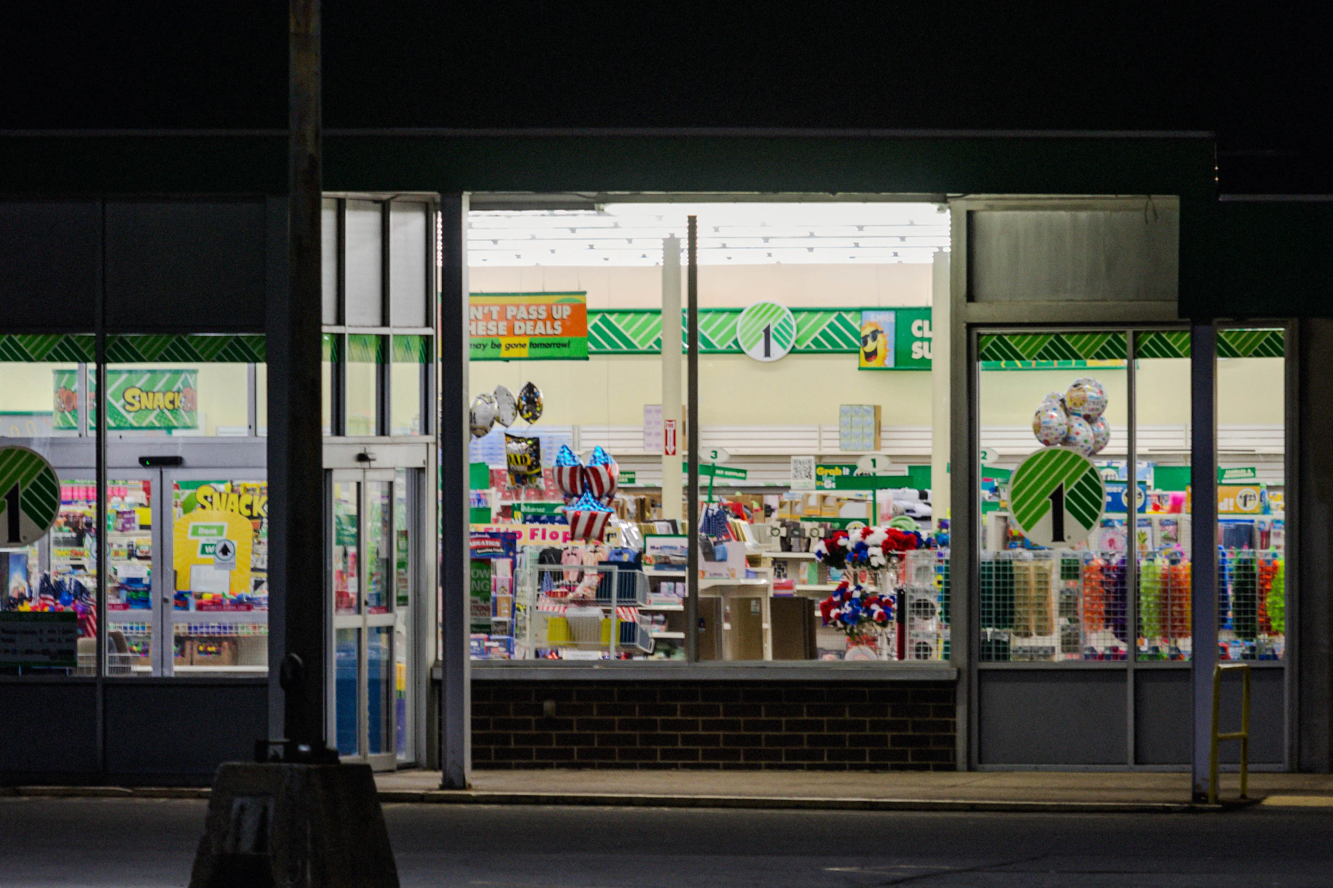 a store front at night with the lights on