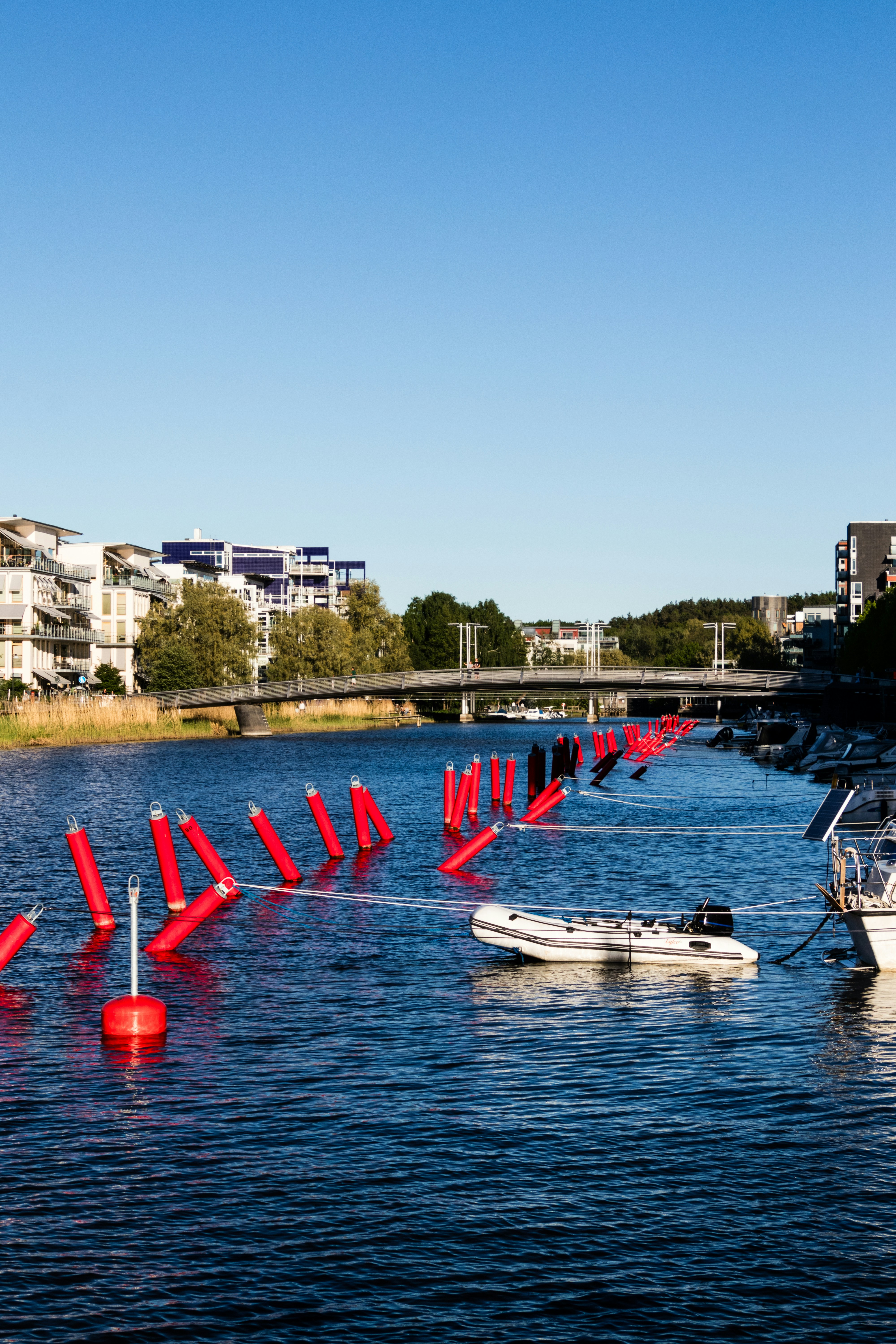 eine Reihe von Booten, die auf einem Gewässer treiben