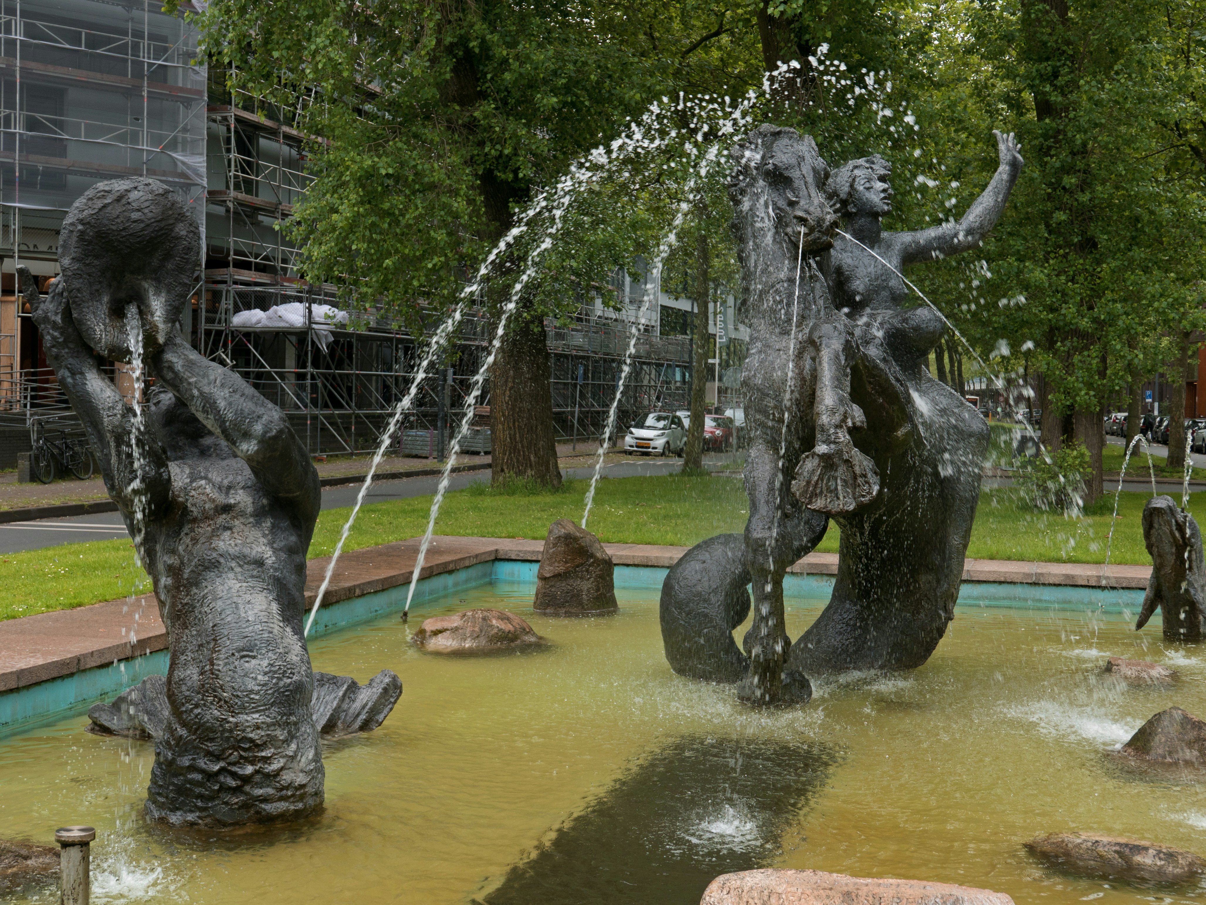 a water fountain with a statue of a woman riding a horse