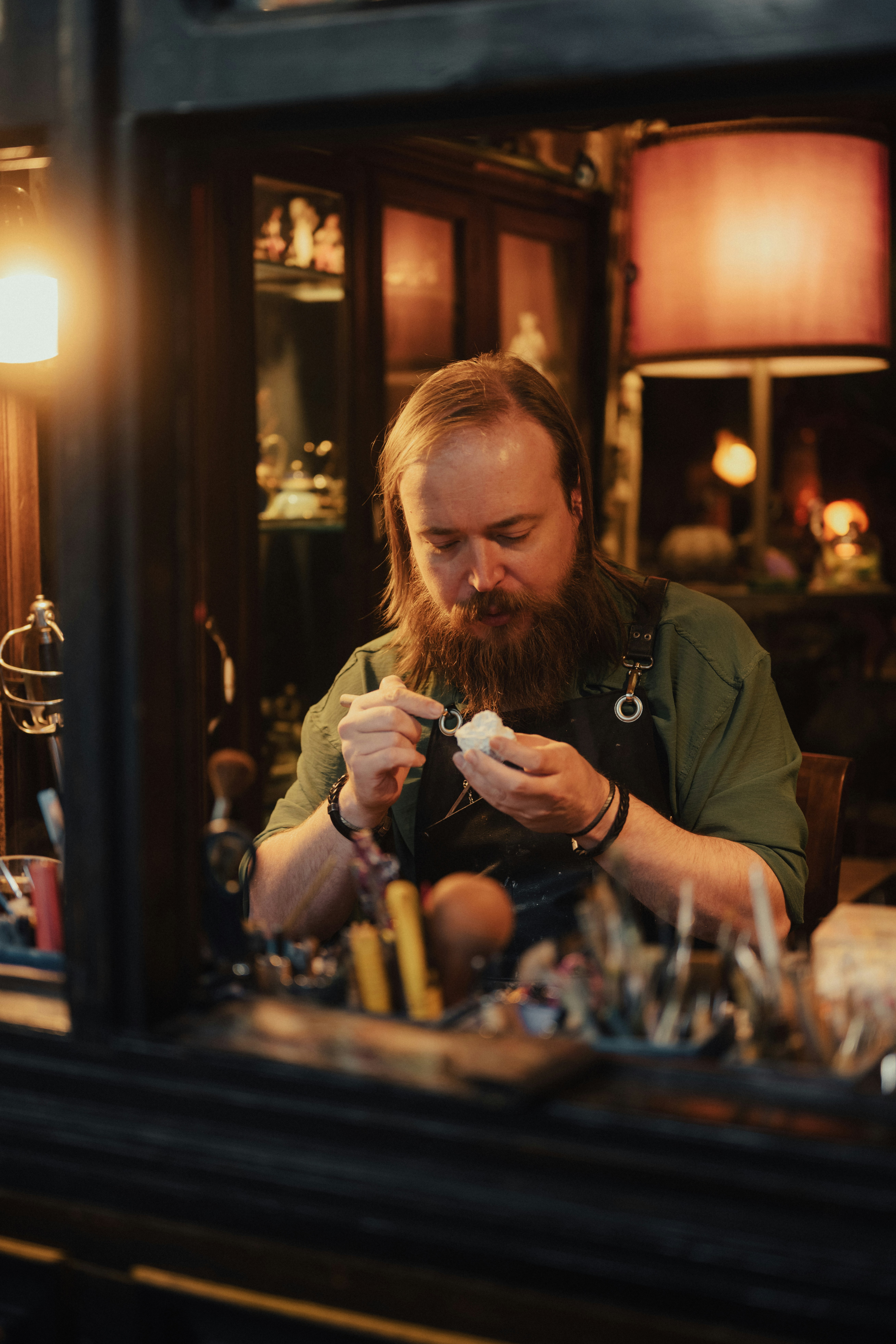a man sitting at a table with a camera in his hand