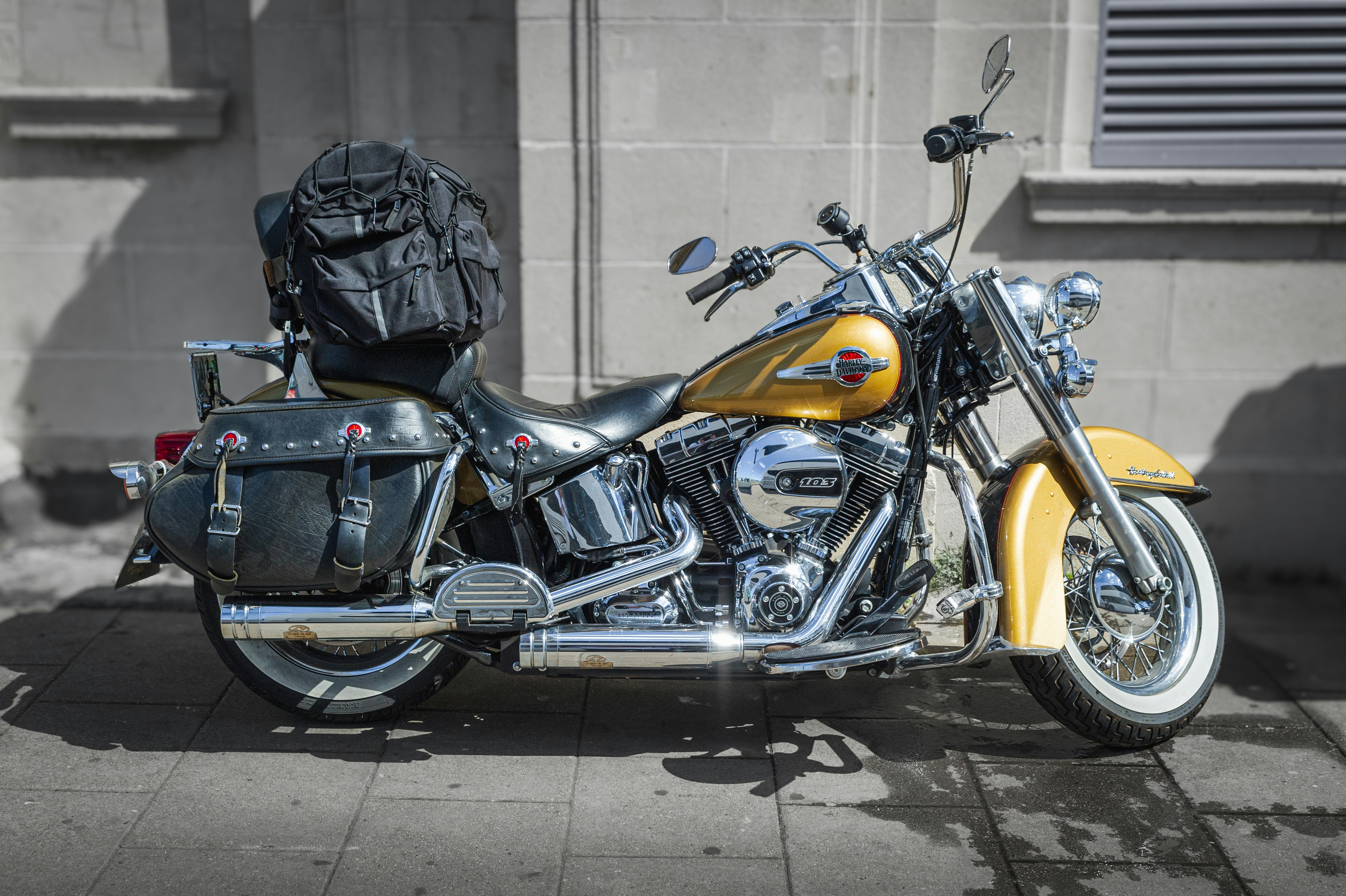 a yellow and black motorcycle parked in front of a building