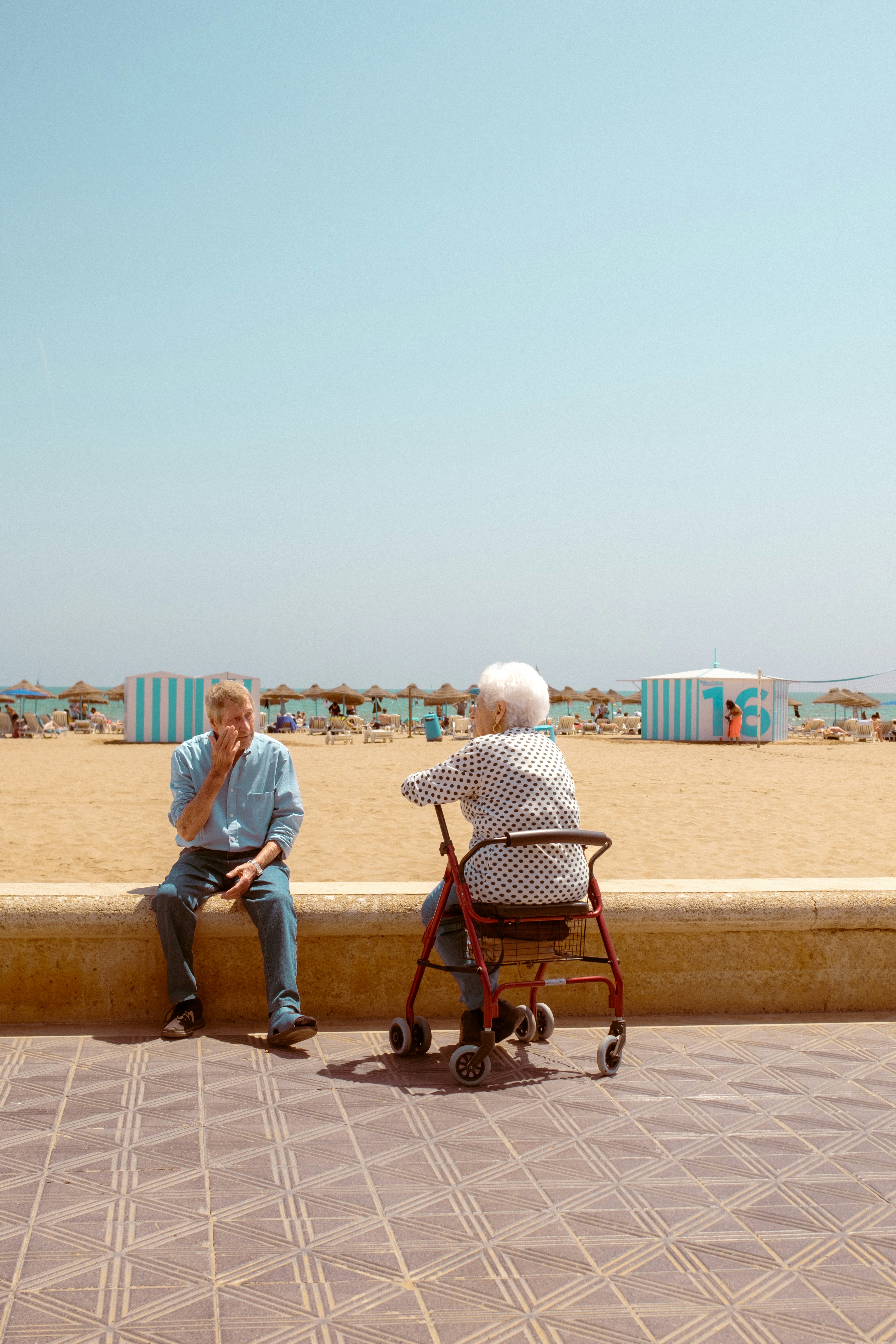 a man sitting on a bench next to a woman