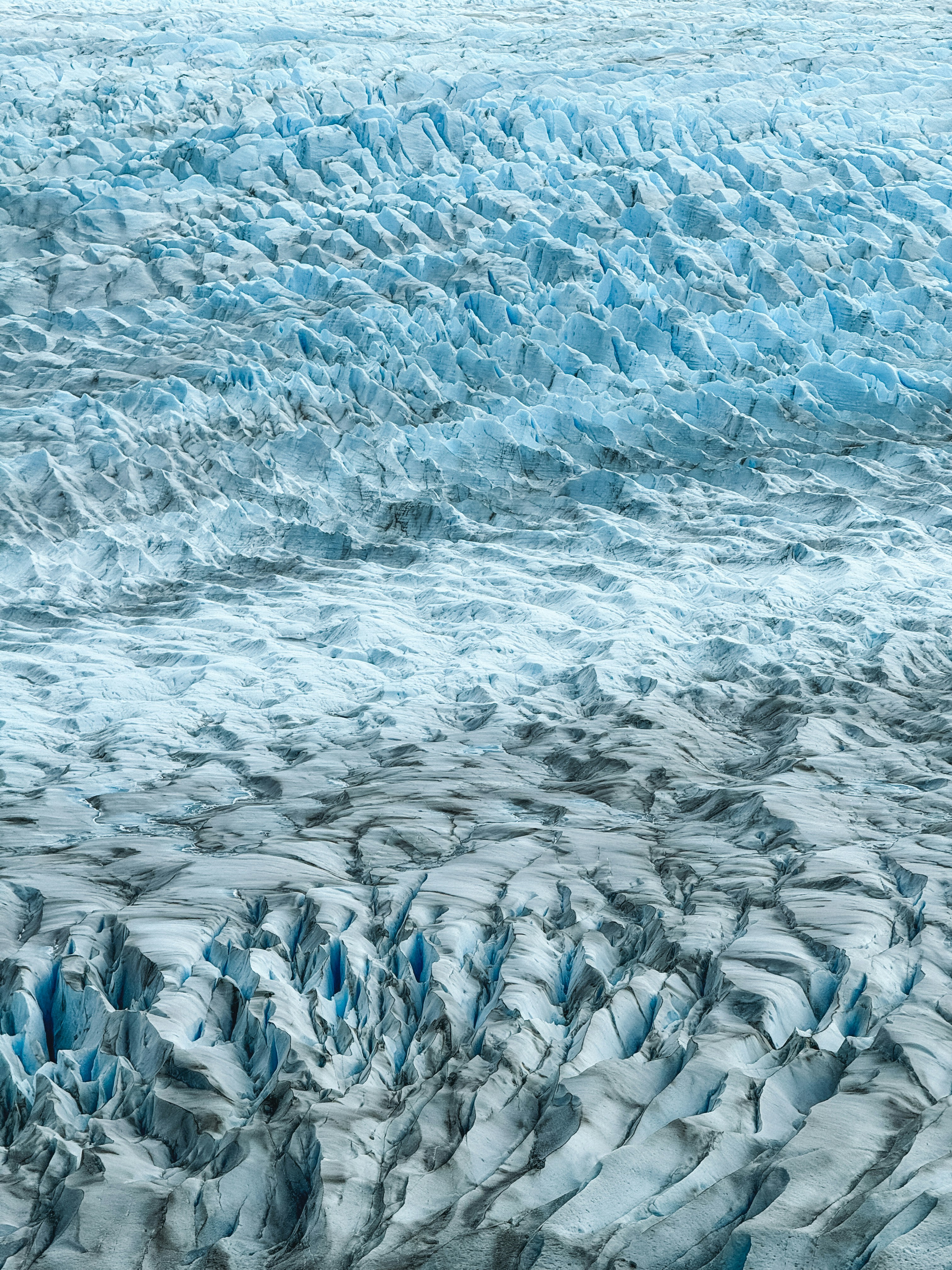 an aerial view of a glacier in the mountains
