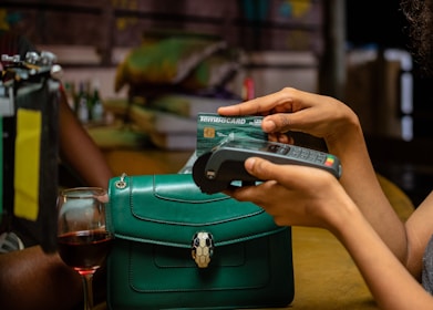 a woman holding a credit card and a cell phone