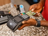 a person holding a credit card in their hand