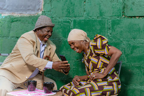 a man and woman sitting next to each other on a bench