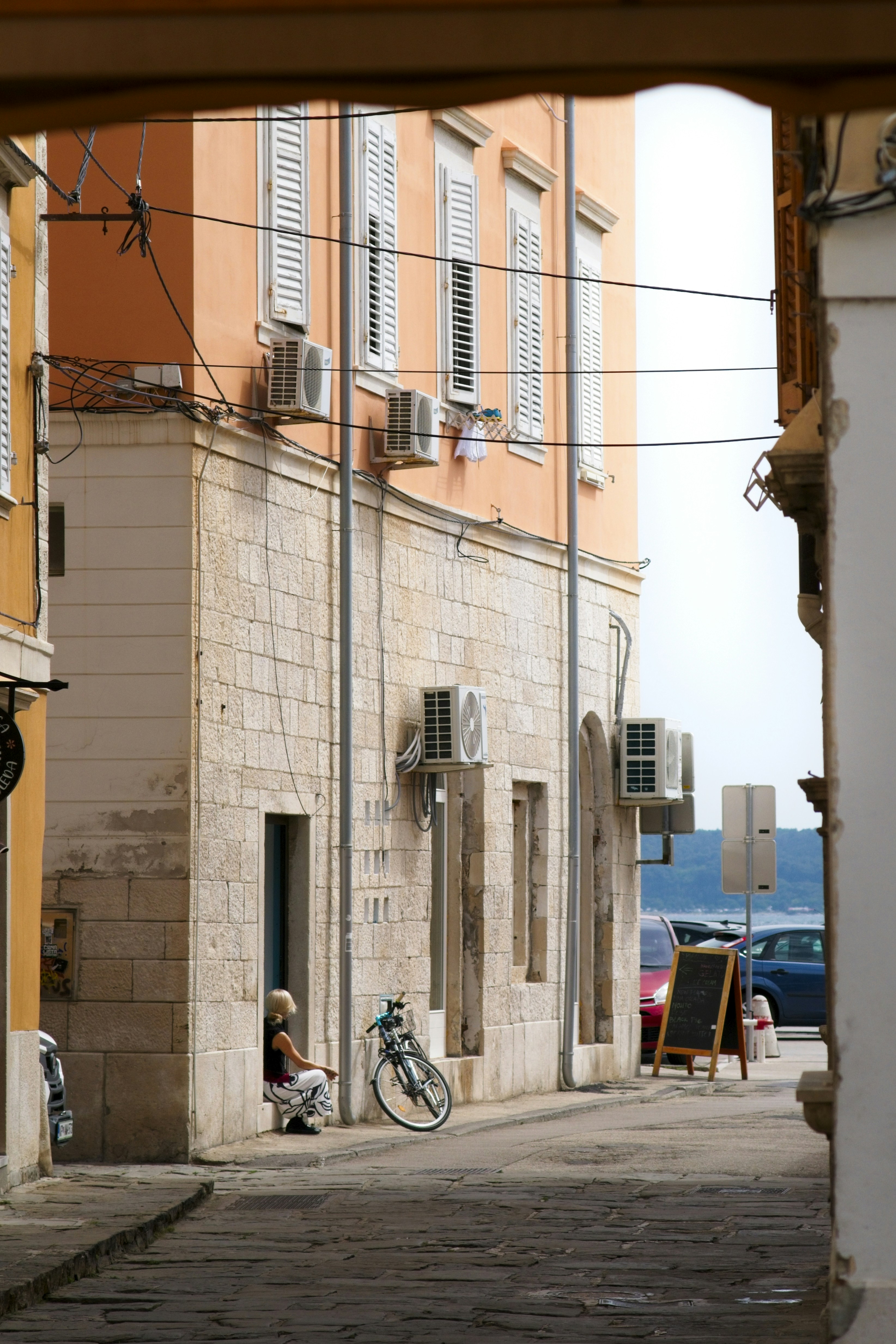 a bike parked on the side of a street next to a building