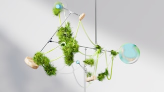 a mobile made of green plants and balls