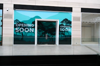 a store front with a painting of trees on it