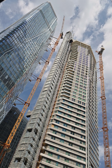a very tall building with some cranes around it