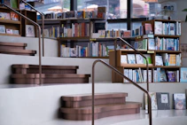 a set of stairs leading up to a bookshelf filled with books