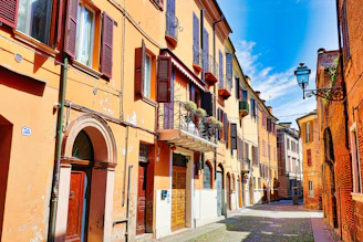 a narrow street lined with buildings and a street light