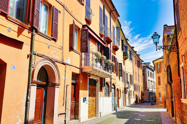 a narrow street lined with buildings and a street light