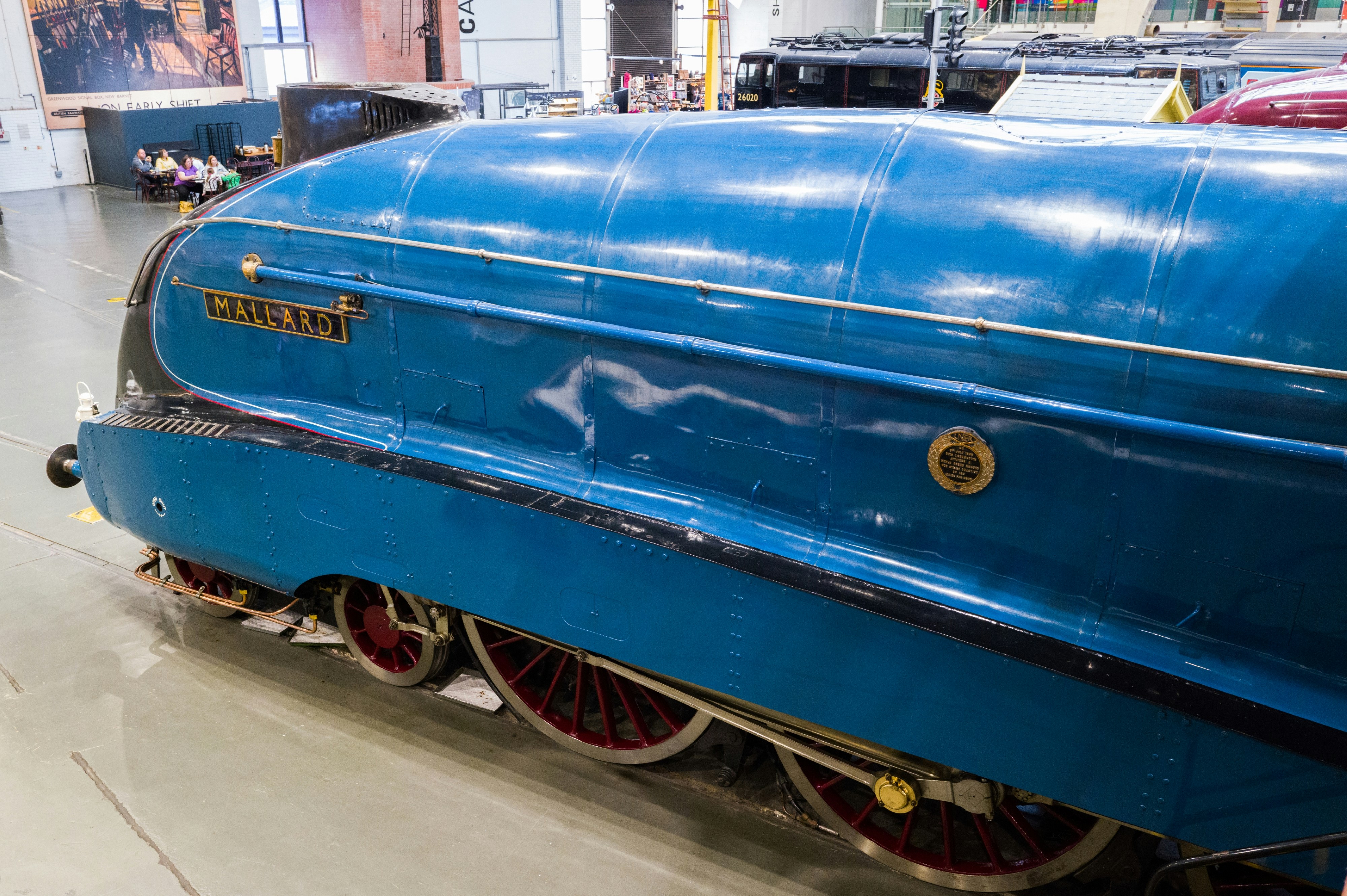 a blue train is on display in a museum