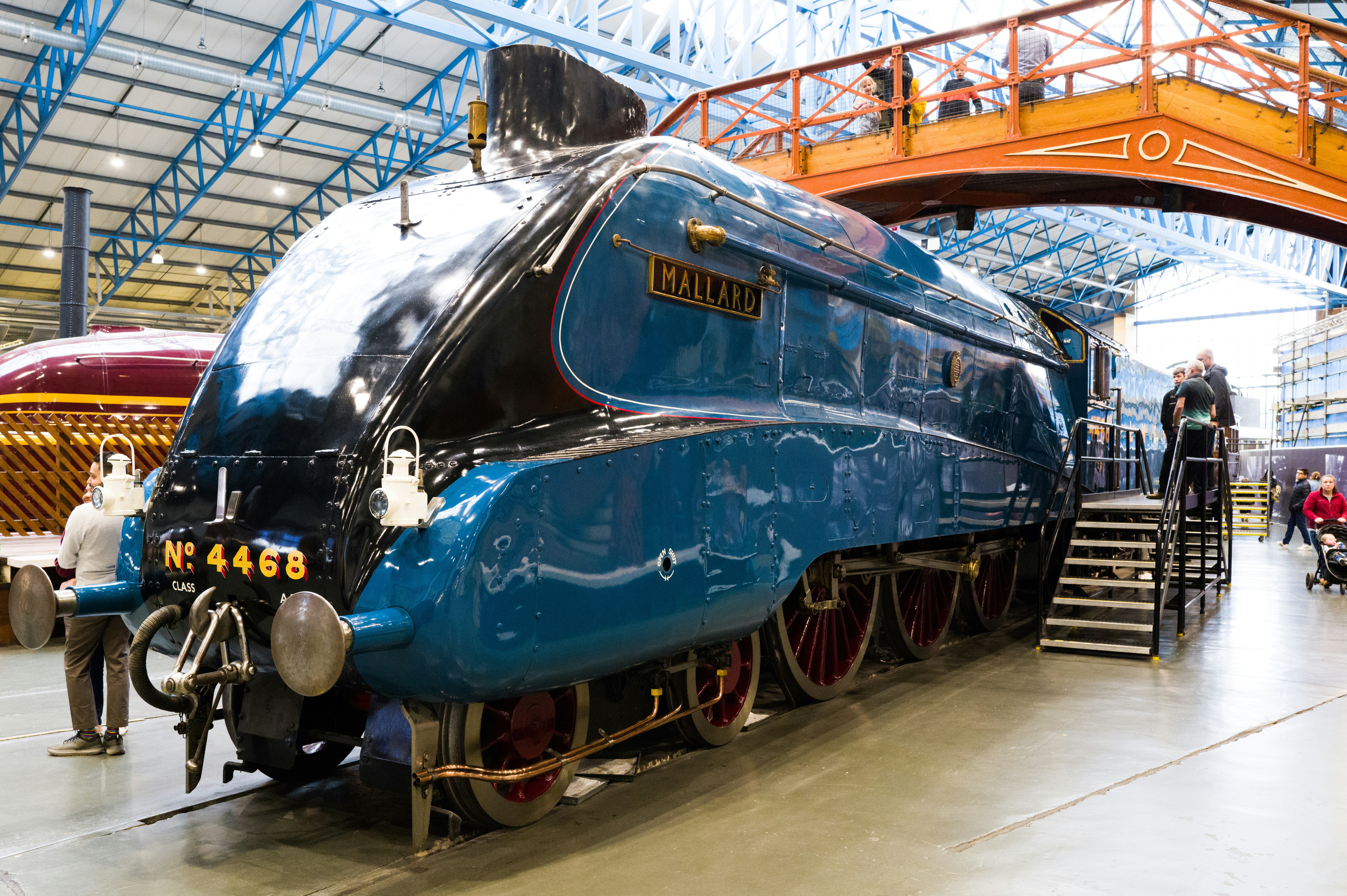 a large blue train sitting inside of a train station
