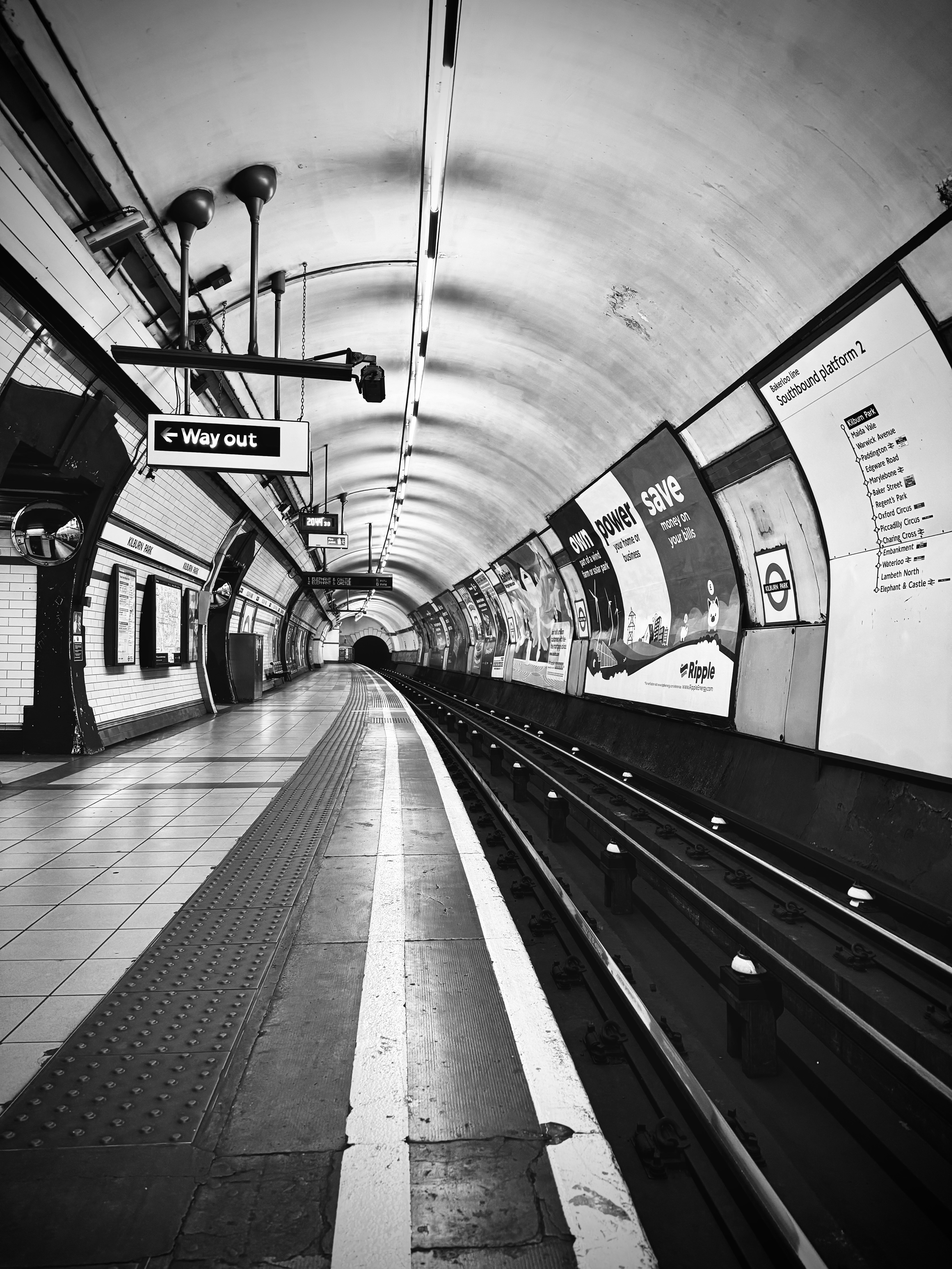 a black and white photo of a subway station