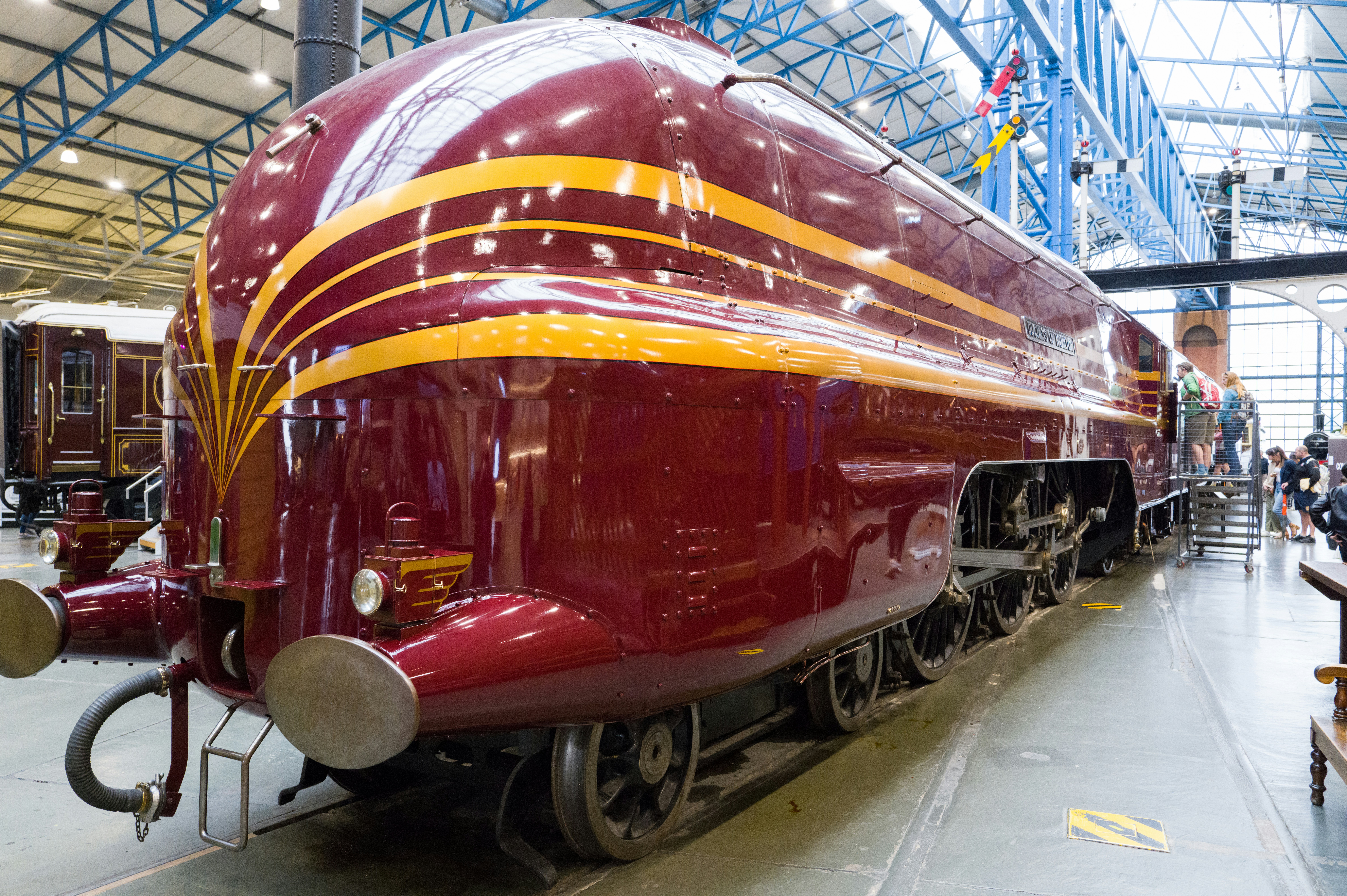 a large red train sitting inside of a train station