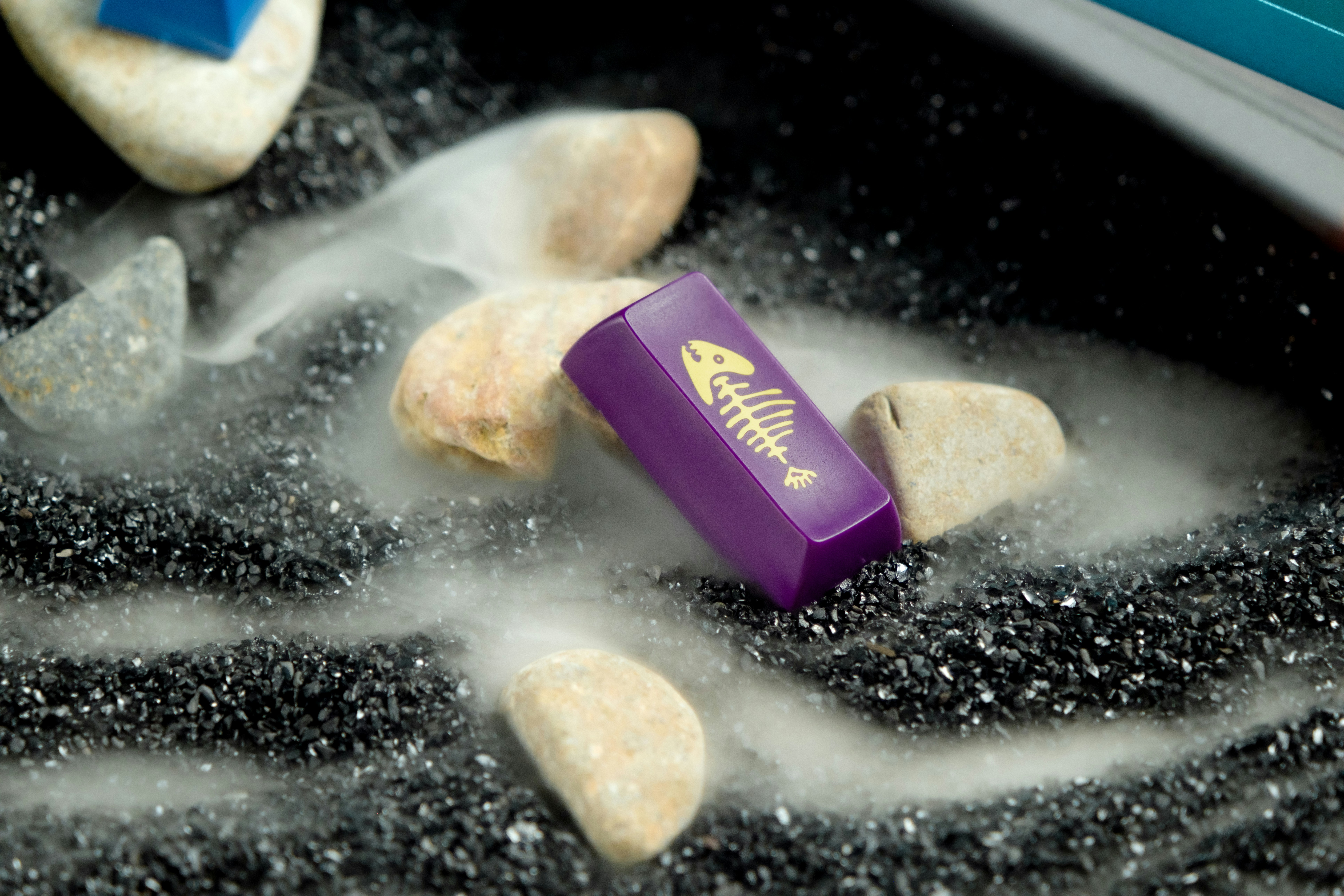 a purple box sitting on top of a pile of rocks