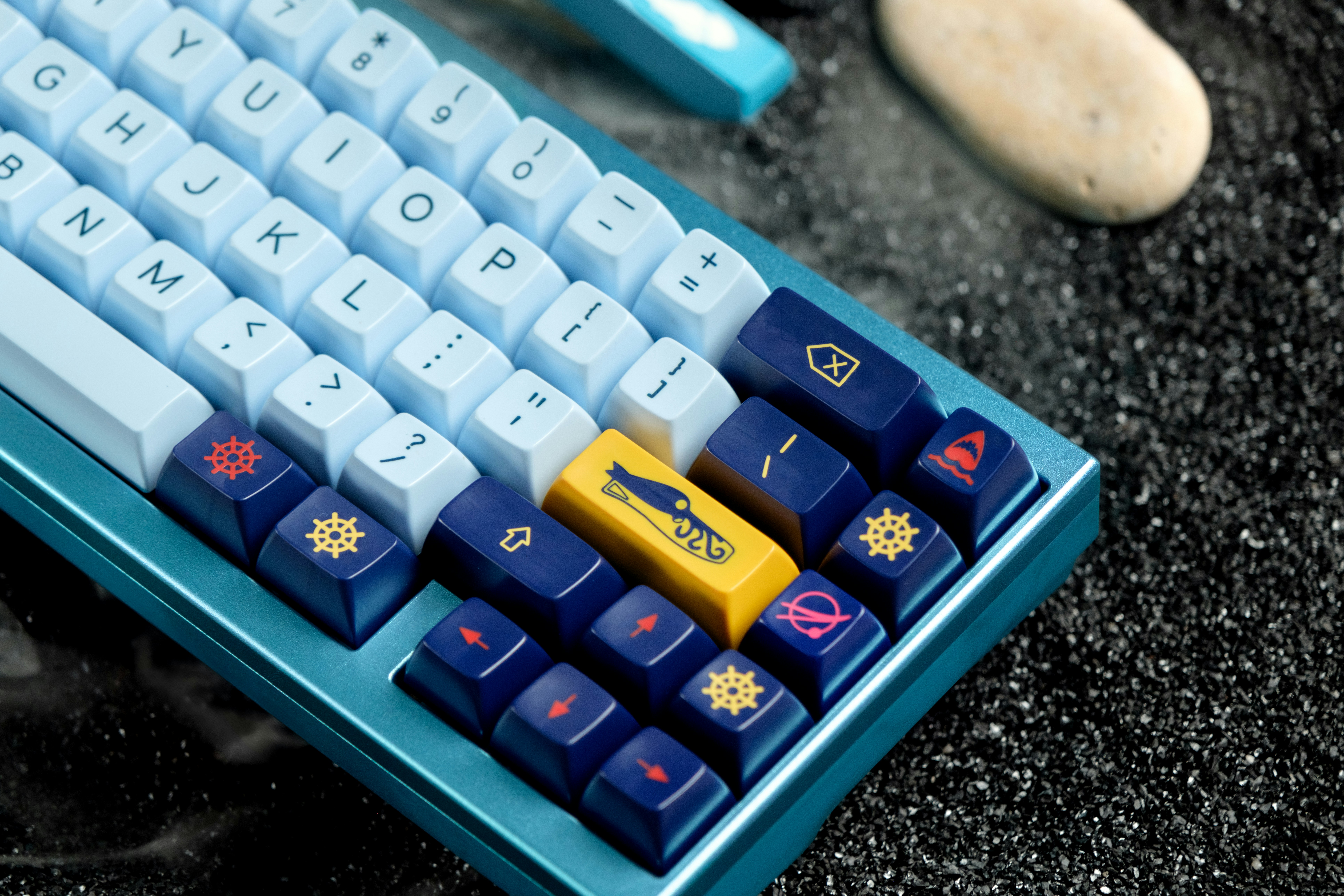 a blue and yellow computer keyboard sitting on top of a table
