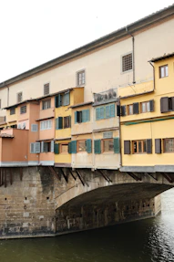 a bridge over a body of water in front of a building