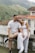 a man and a woman are sitting on a wall