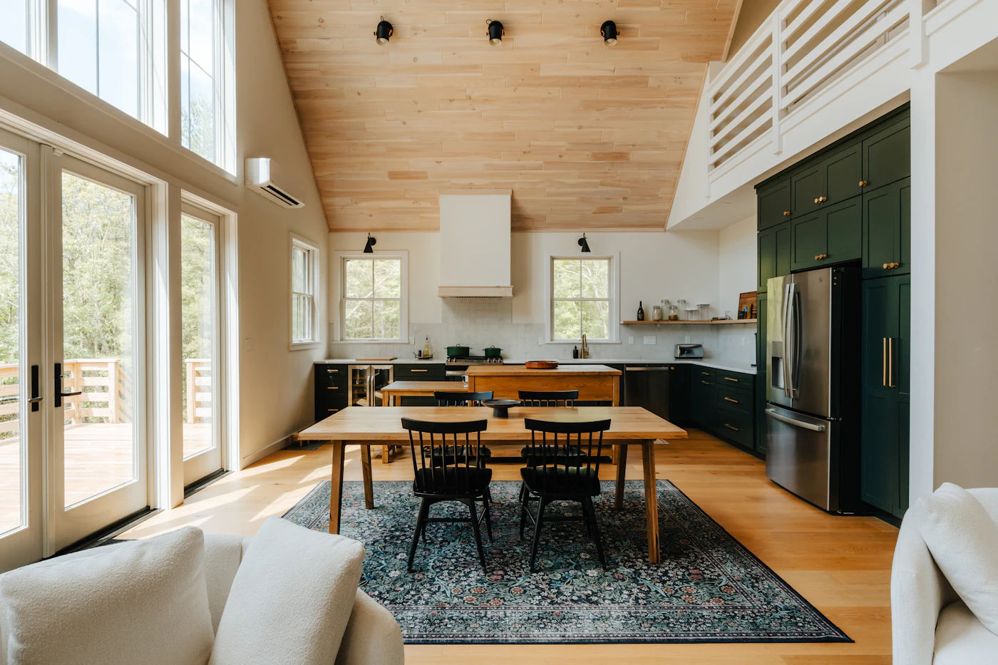Large open kitchen and dining area in a modern farmhouse style barndominium floor plan