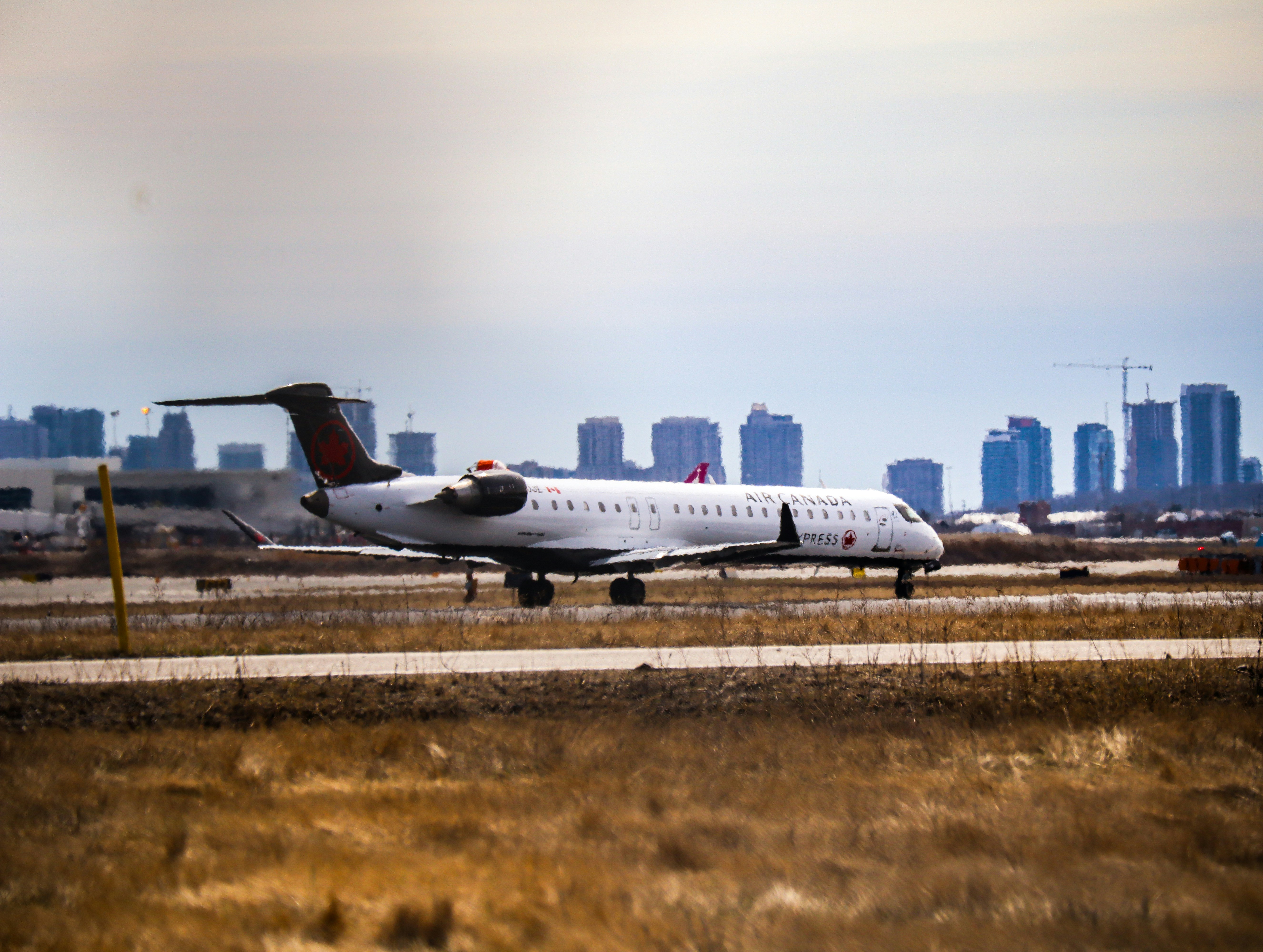 a large white airplane on a run way, Ready for takeoff. Air Canada Express.