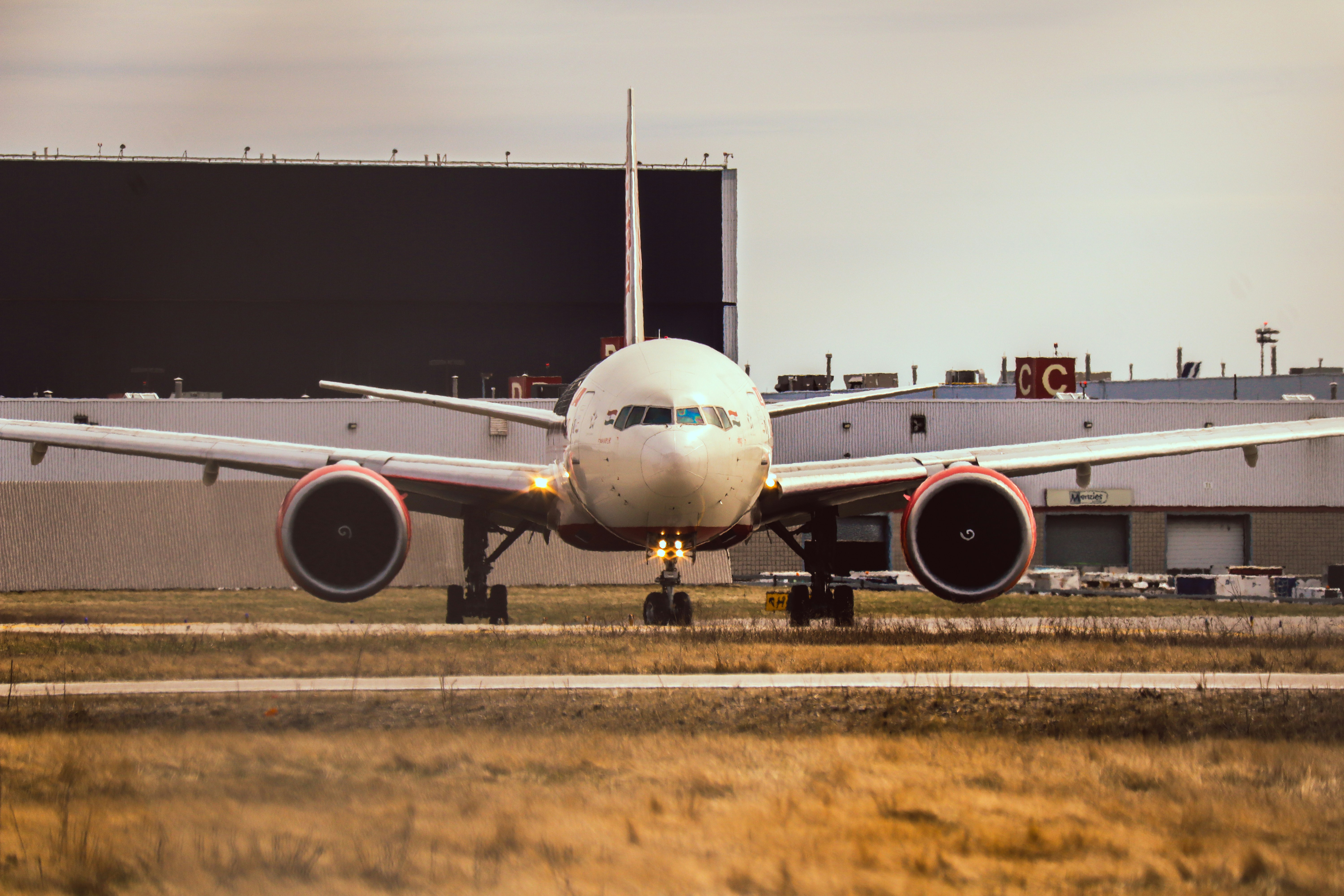 a large jetliner sitting on top of an airport runway