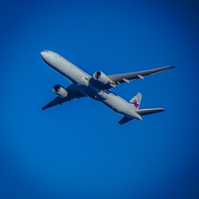 a large jetliner flying through a blue sky