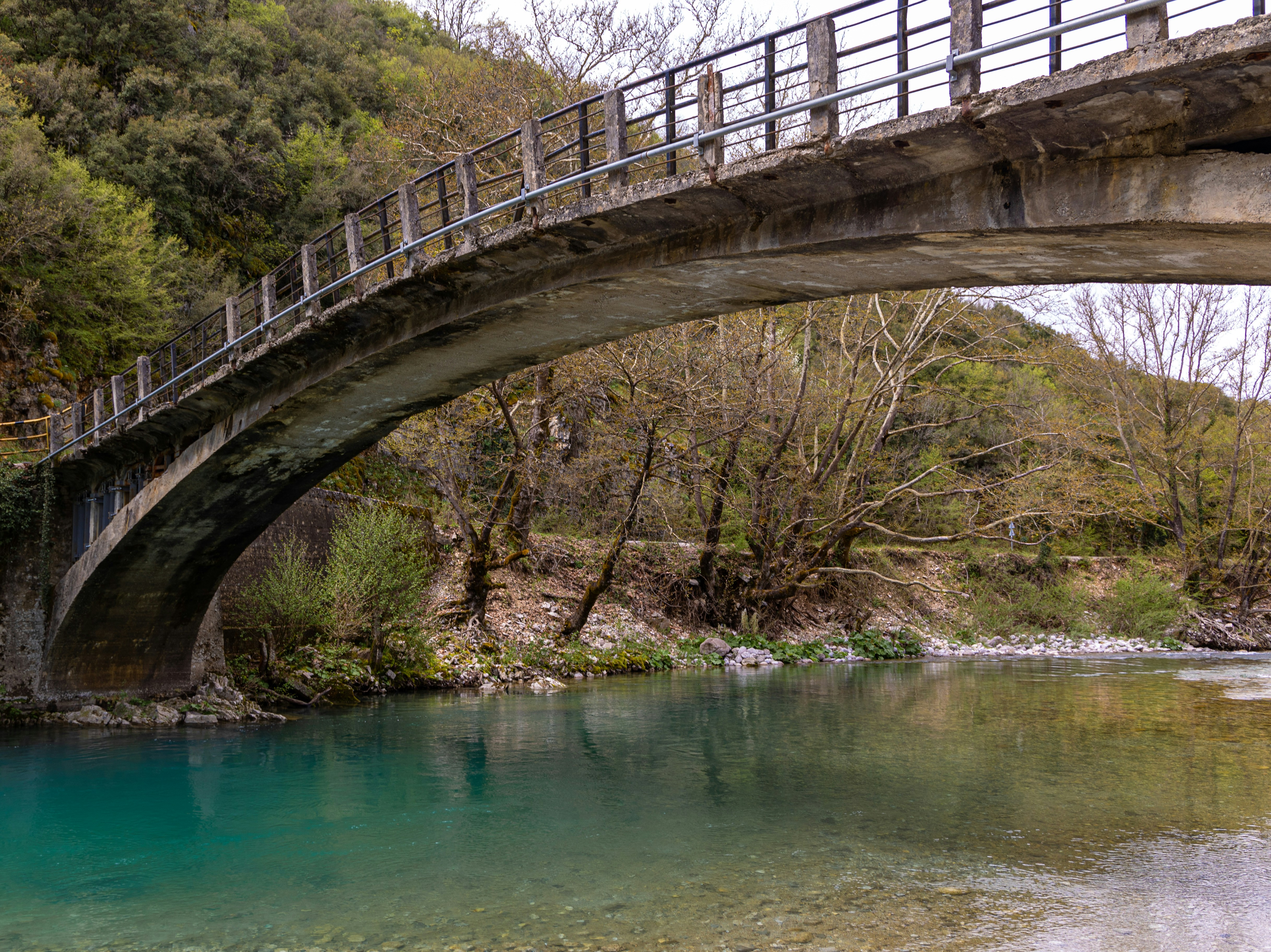 a bridge over a river with clear water