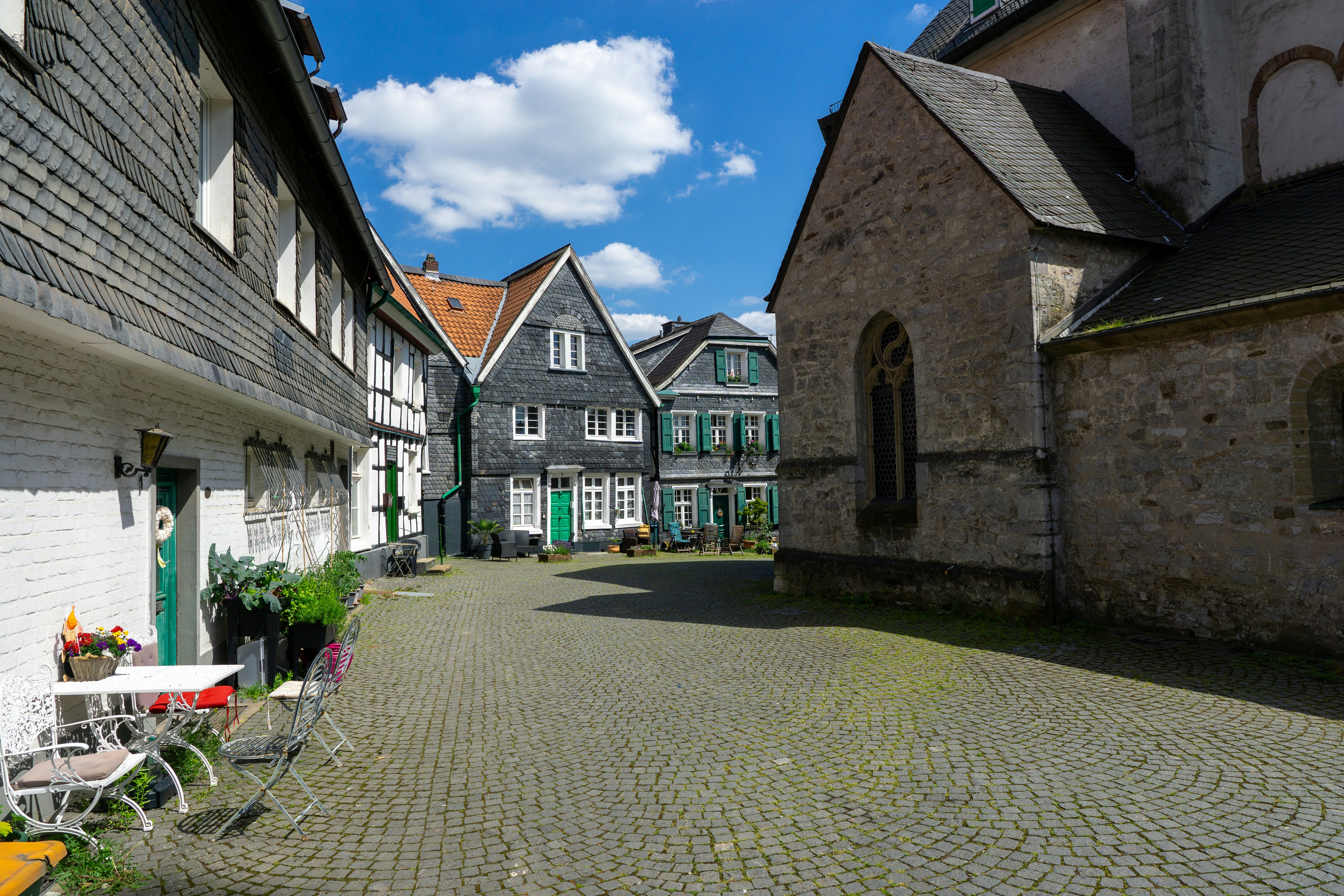 a cobblestone street lined with old buildings