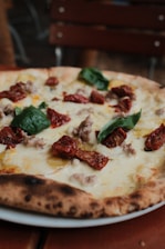 a pizza sitting on top of a white plate
