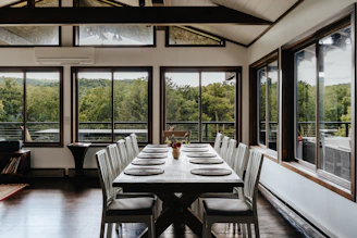 a dining room with a long table and chairs