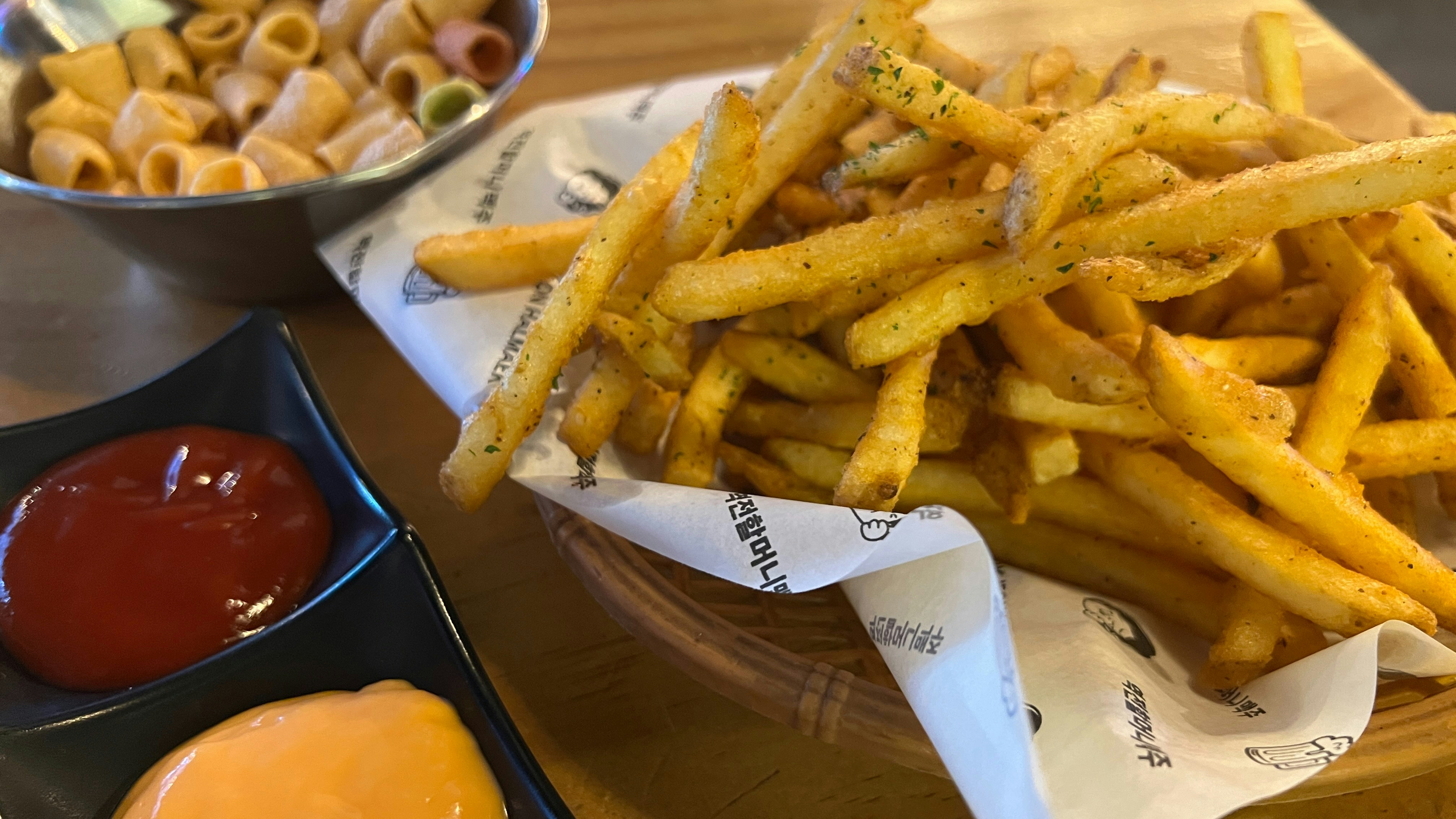 Crispy golden French fries served with ketchup and dipping sauce