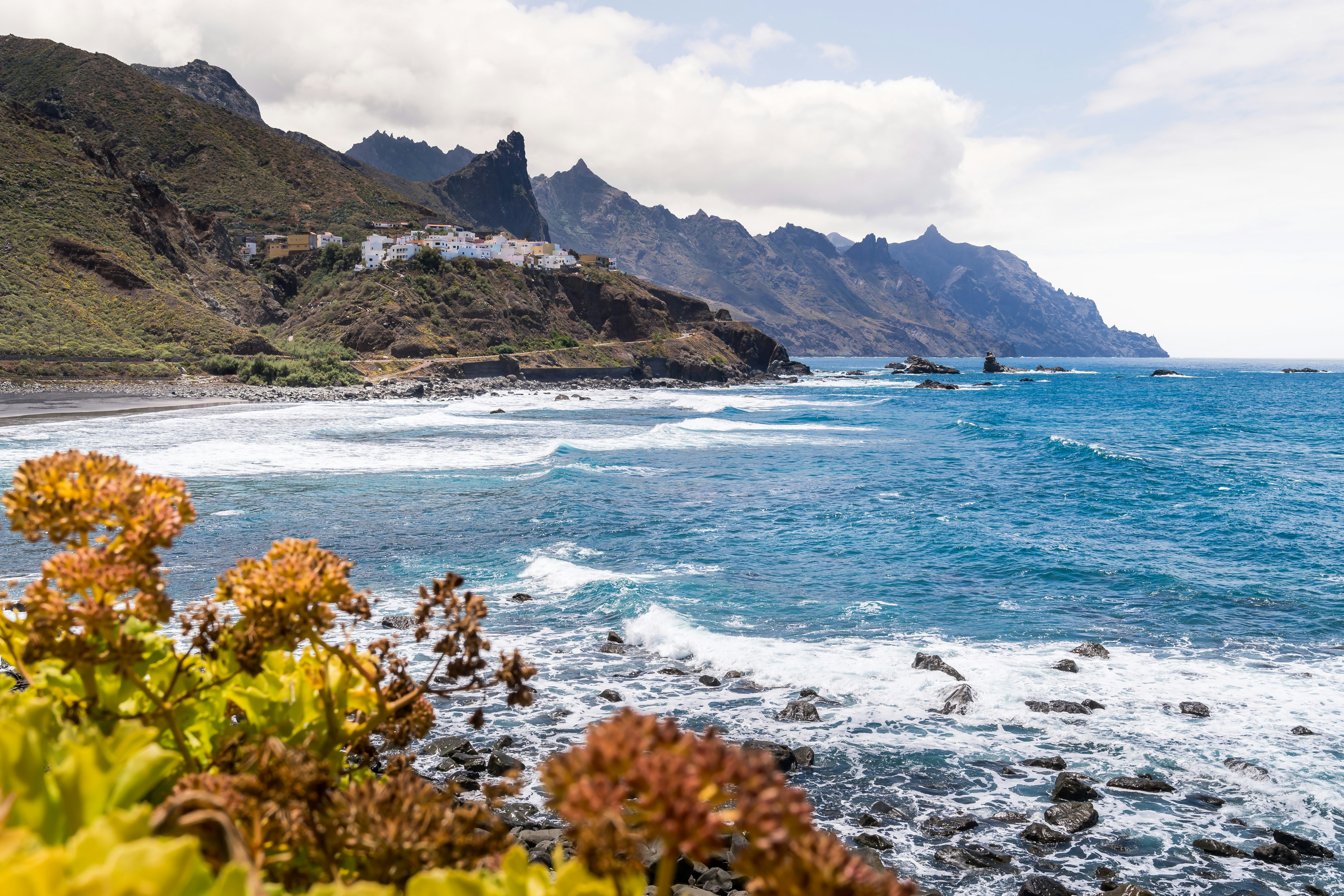 a view of a beach with a mountain in the background