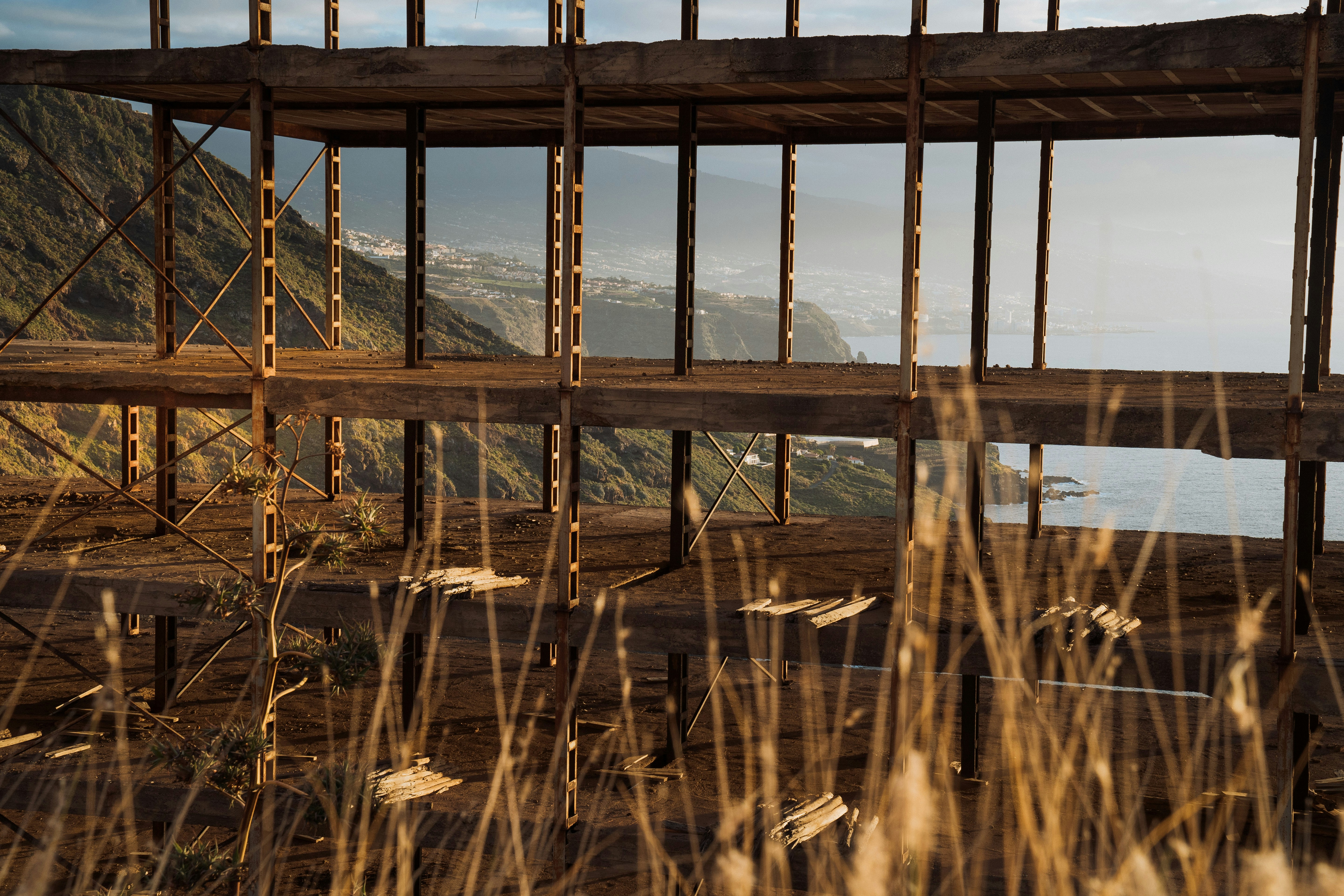 a view of the ocean through a fenced in area