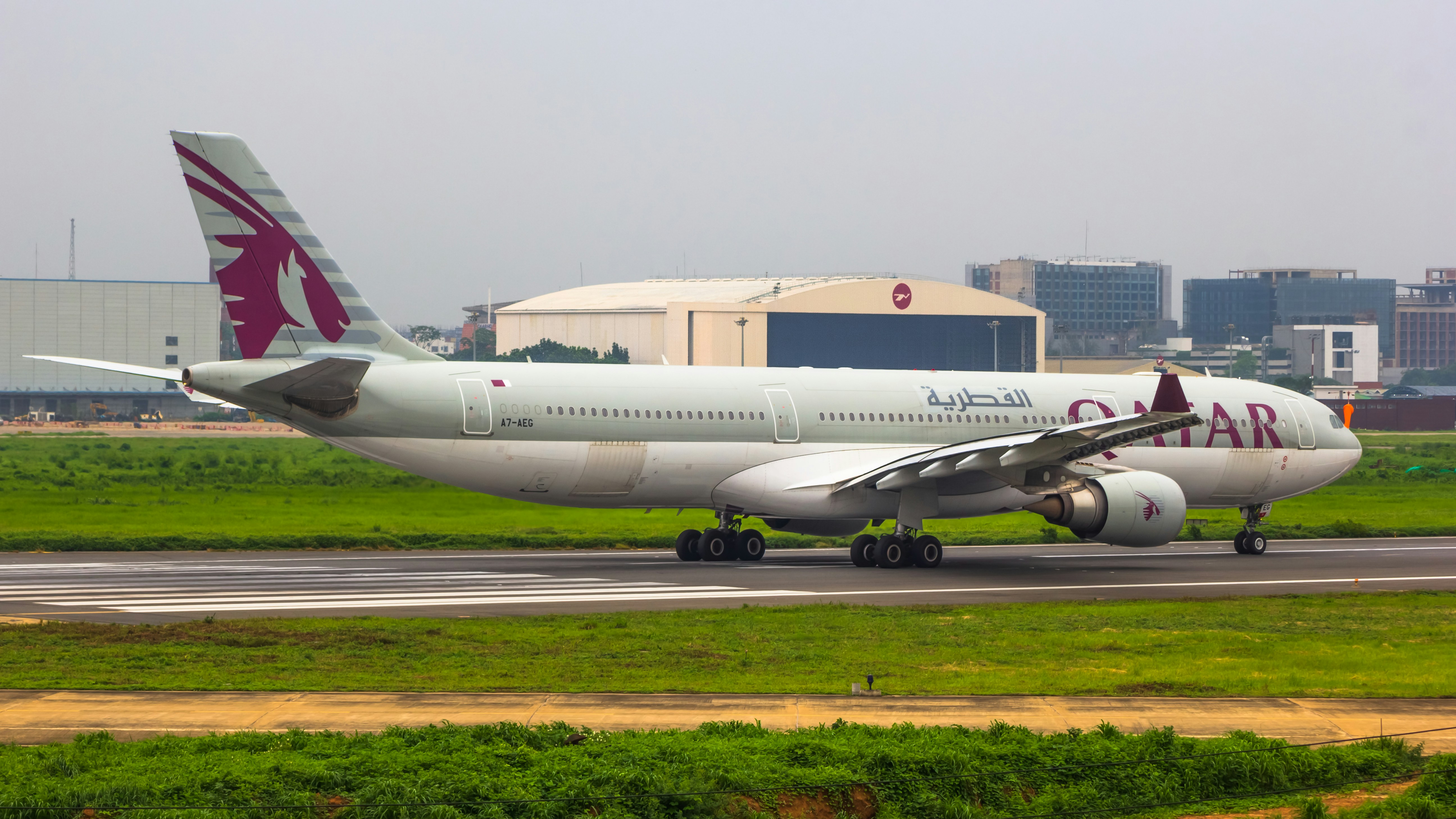 a large passenger jet sitting on top of an airport runway, Qatar Airways | A330