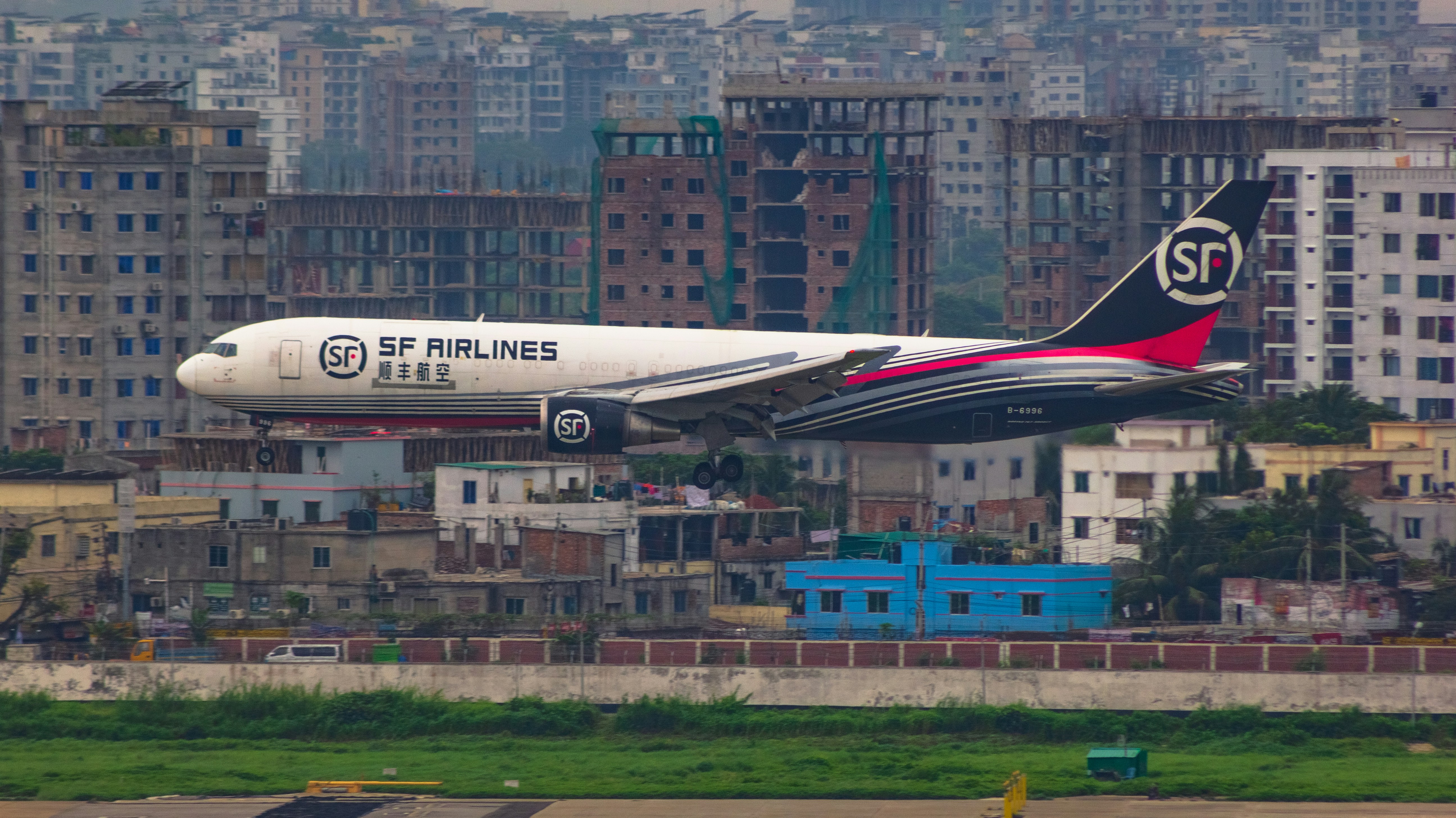 a large jetliner taking off from an airport runway, s cargo b767