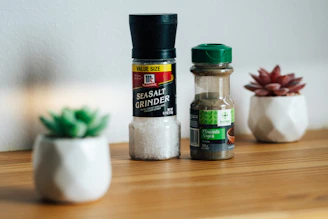 a wooden table topped with salt and pepper shakers