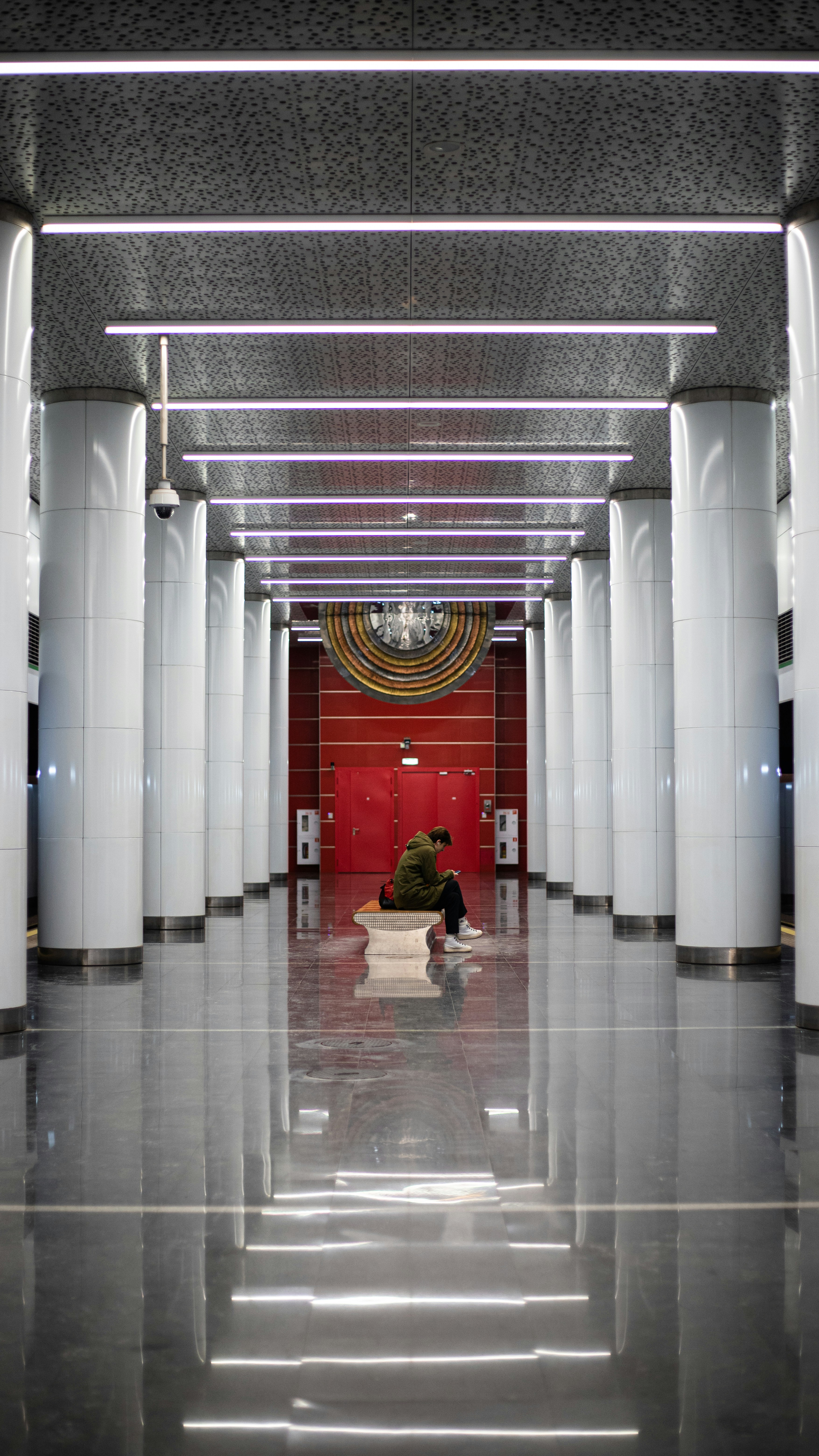 a person sitting on a bench in a building