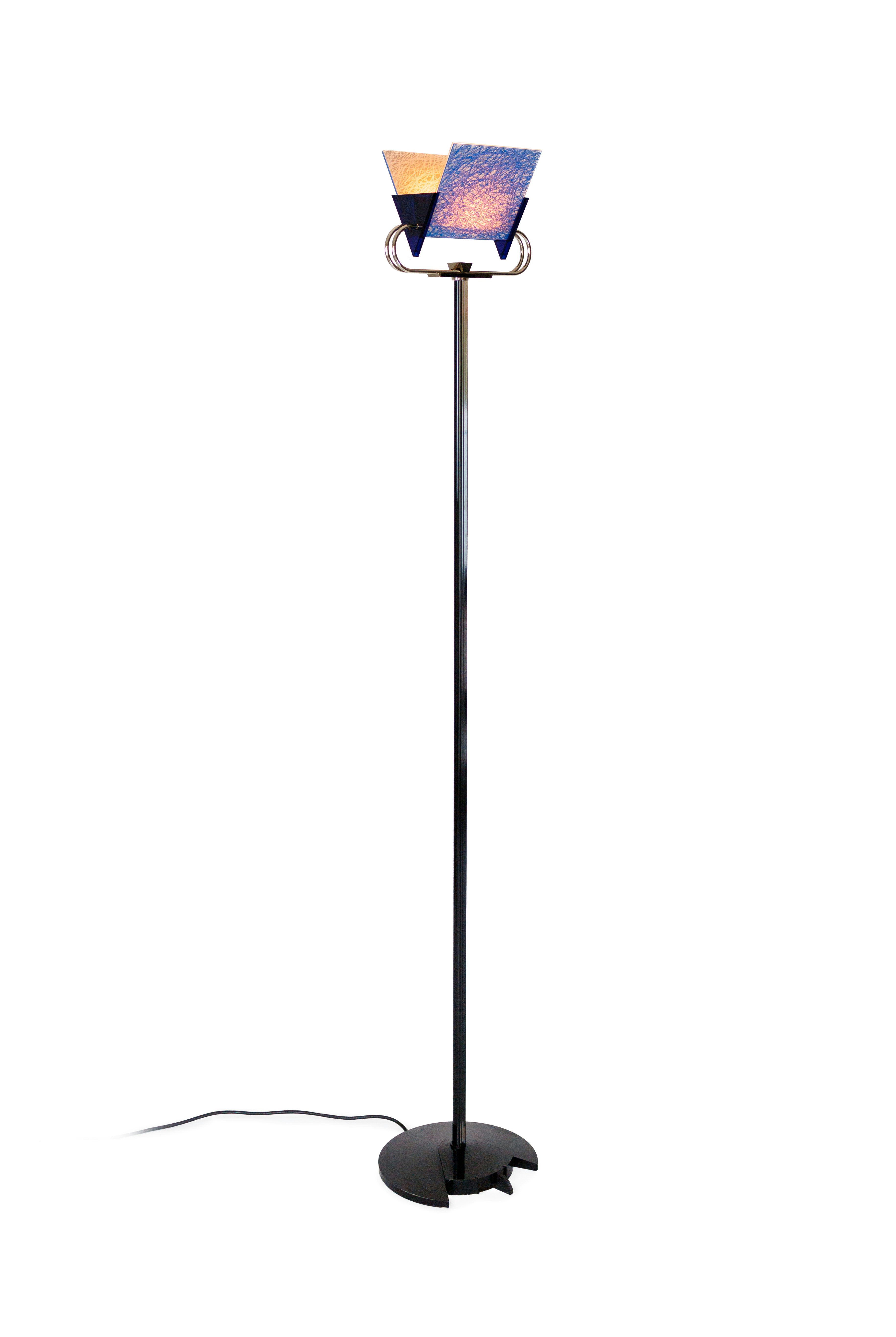 a floor lamp with a blue shade on top of it